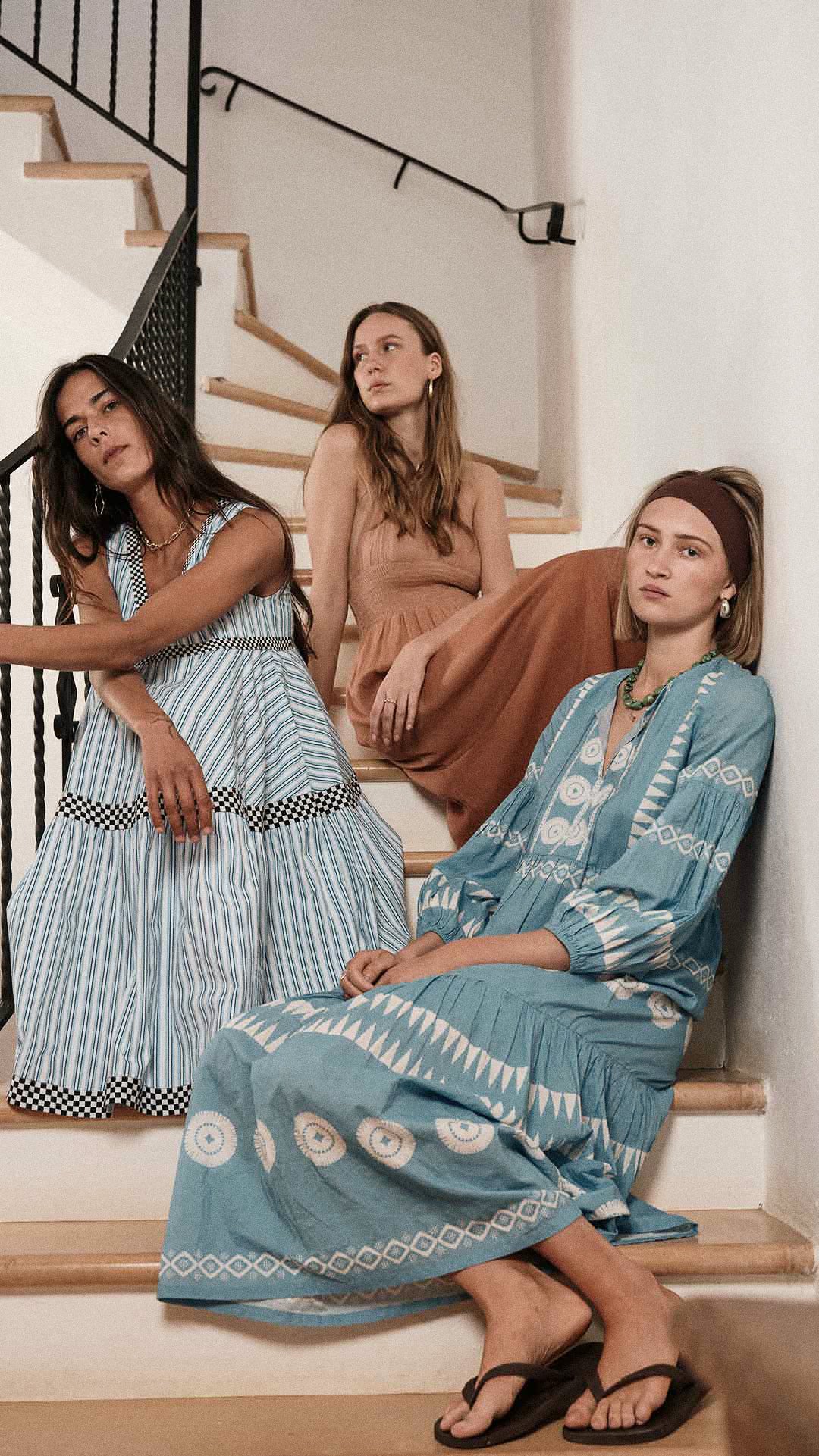 Three women wearing the sorento dress (pink dress), palma dress (blue dress) and the soho short sleeve dress (striped dress). Perfect for vacation and formal wear. 